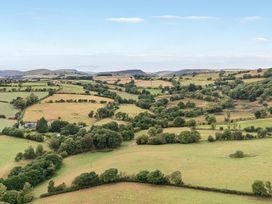 A landscape with fields and trees near Dam View Shepherds Hut Upper Bwlch near Rhayader