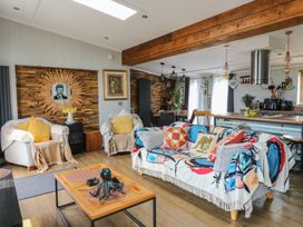 A living room with a sofa and coffee table at Coogee View in Maenygroes near New Quay