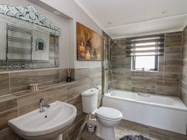 A bathroom with a bathtub and sink at Coogee View in Maenygroes near New Quay