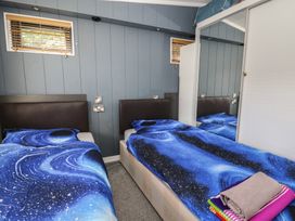 A bedroom with two beds and towels at Coogee View in Maenygroes near New Quay