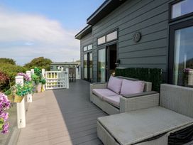 A deck with outdoor furniture at Coogee View in Maenygroes near New Quay