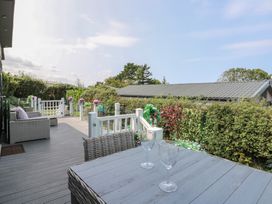 A deck with a table and chairs at Coogee View in Maenygroes near New Quay