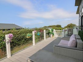 An outdoor area with seating and plants at Coogee View in Maenygroes near New Quay