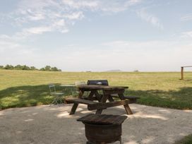 A picnic table and chairs in an outdoor area at Hollie in Raglan