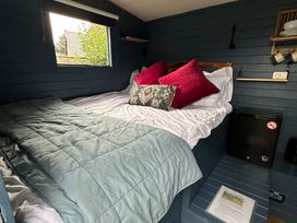 A bedroom with a bed and window at Acres Meadow in Maiden Newton