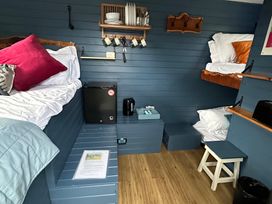 A bedroom with bunk beds and a fridge at Acres Meadow in Maiden Newton