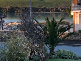 A view with palm tree and water body at Tidal View in Newquay