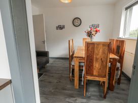 A dining room with a wooden table and chairs at The Island's View in Gortahork, County Donegal