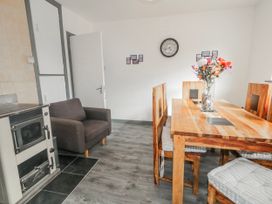 A dining room with a wooden table and chairs at The Island's View in Gortahork, County Donegal