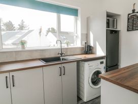 A kitchen with a sink and washing machine at The Island's View in Gortahork, County Donegal