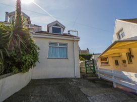An outdoor view of a house with a driveway and plants at Harbour High Annex in Fishguard