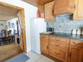 A kitchen with fridge, microwave, and cabinets at Harbour High Annex in Fishguard