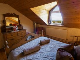 A bedroom with a bed and dresser at Harbour High Annex in Fishguard