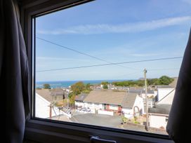 A view of the sea and houses from a window at Harbour High Annex in Fishguard