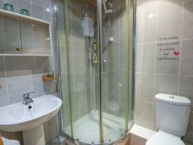 A bathroom with a shower, toilet, and sink at Harbour High Annex in Fishguard