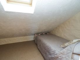 A bedroom with a bed and window at Harbour High Annex in Fishguard