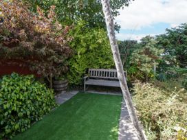 A garden with a bench and greenery at Harbour High Annex in Fishguard