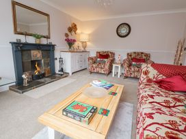 A living room with a fireplace two armchairs a sofa and a coffee table at 2 Mountain View in Chirk
