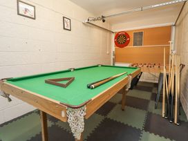 A game room with a pool table, a dartboard, and a foosball table at 2 Mountain View in Chirk