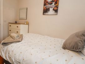 A bedroom with a bed and dresser at 2 Mountain View in Chirk