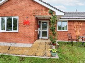 A house exterior with a front door and seating area at 2 Mountain View Chirk