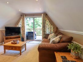 A living room with a sofa and television at Driftwood - 54 Valley Lodge St Ann's Chapel, Cornwall