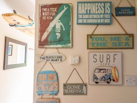 A wall with beach-themed decorations at Driftwood - 54 Valley Lodge, St Ann's Chapel, Cornwall
