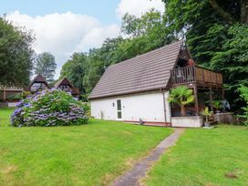 A house with a balcony and garden at Driftwood - 54 Valley Lodge St Ann's Chapel, Cornwall