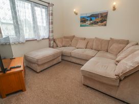 A living room with a couch and television at 14 Bosvigo Ruan Major near Penhale