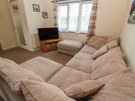 A living room with a sofa and television at 14 Bosvigo Ruan Major near Penhale