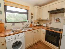 A kitchen with a washing machine and sink at 14 Bosvigo in Ruan Major near Penhale