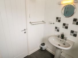 A bathroom with a wash basin and mirror at 14 Bosvigo, Ruan Major near Penhale