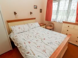 A bedroom with a bed and nightstand at 14 Bosvigo Ruan Major near Penhale