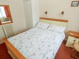 A bedroom with a bed and bedside table at 14 Bosvigo near Ruan Major