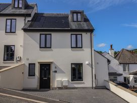 A house with solar panels and a driveway at Wagtail Cottage in Lyme Regis