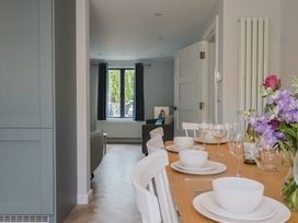 A kitchen with a dining table set for a meal at Wagtail Cottage in Lyme Regis