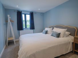 A bedroom with a bed and window at Wagtail Cottage in Lyme Regis