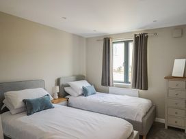 A bedroom with two single beds and a dresser at Wagtail Cottage in Lyme Regis