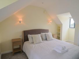 A bedroom with a bed and bedside table at Wagtail Cottage in Lyme Regis
