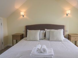 A bedroom with a bed and bedside tables at Wagtail Cottage in Lyme Regis