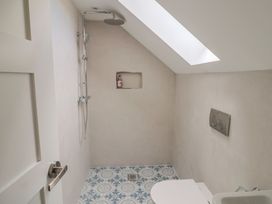 A bathroom with a shower and toilet at Wagtail Cottage in Lyme Regis