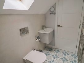 A bathroom with a toilet and sink at Wagtail Cottage in Lyme Regis