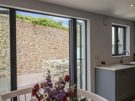 A kitchen with a table and chairs at Wagtail Cottage in Lyme Regis