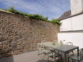 An outdoor seating area with a table and chairs at Wagtail Cottage in Lyme Regis