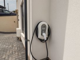 An electric vehicle charger mounted on a wall at Wagtail Cottage in Lyme Regis