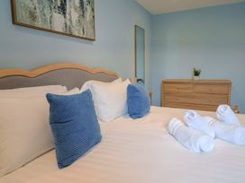 A bedroom with bed and towels at Wagtail Cottage in Lyme Regis