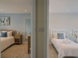 A bedroom with a bed and bedside table at Wagtail Cottage in Lyme Regis