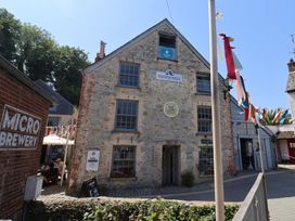 An outdoor scene featuring Town Mill building with microbrewery sign in Lyme Regis