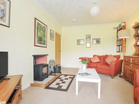 A living room with a fireplace and sofa at Jordan Cottage in Fowey