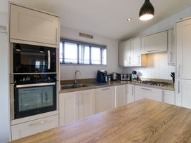 A kitchen with built in oven microwave sink and counter appliances at Angel Lodge - No 27 in Fornham St Genevieve near Bury St Edmunds